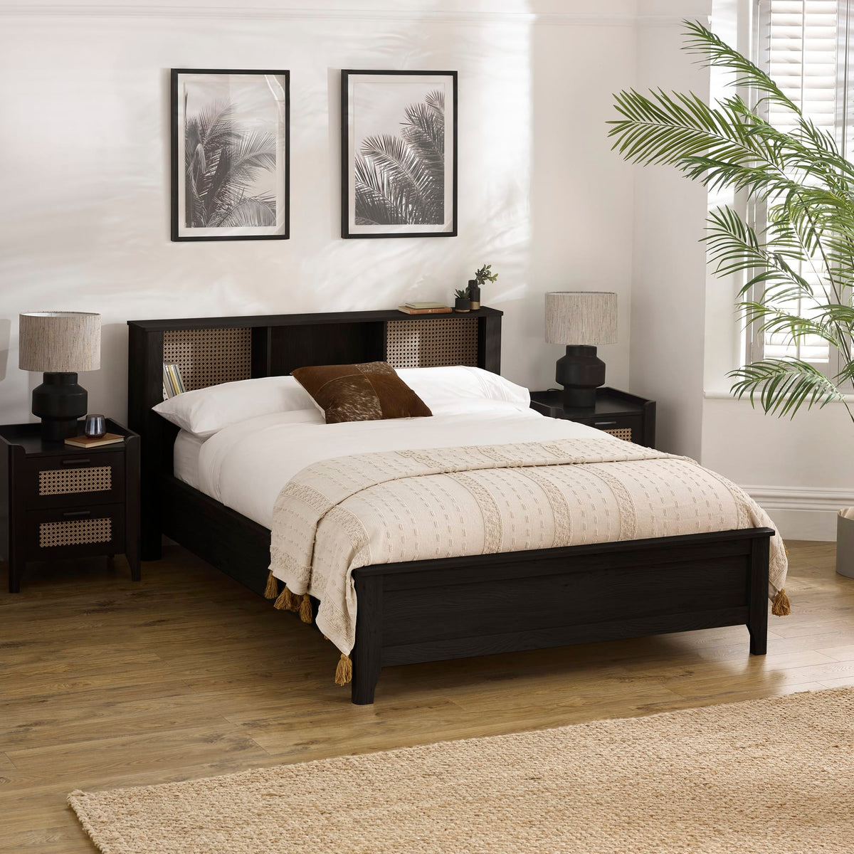 Bedroom with dark wood bed frame, white bedding, and decorative elements.
