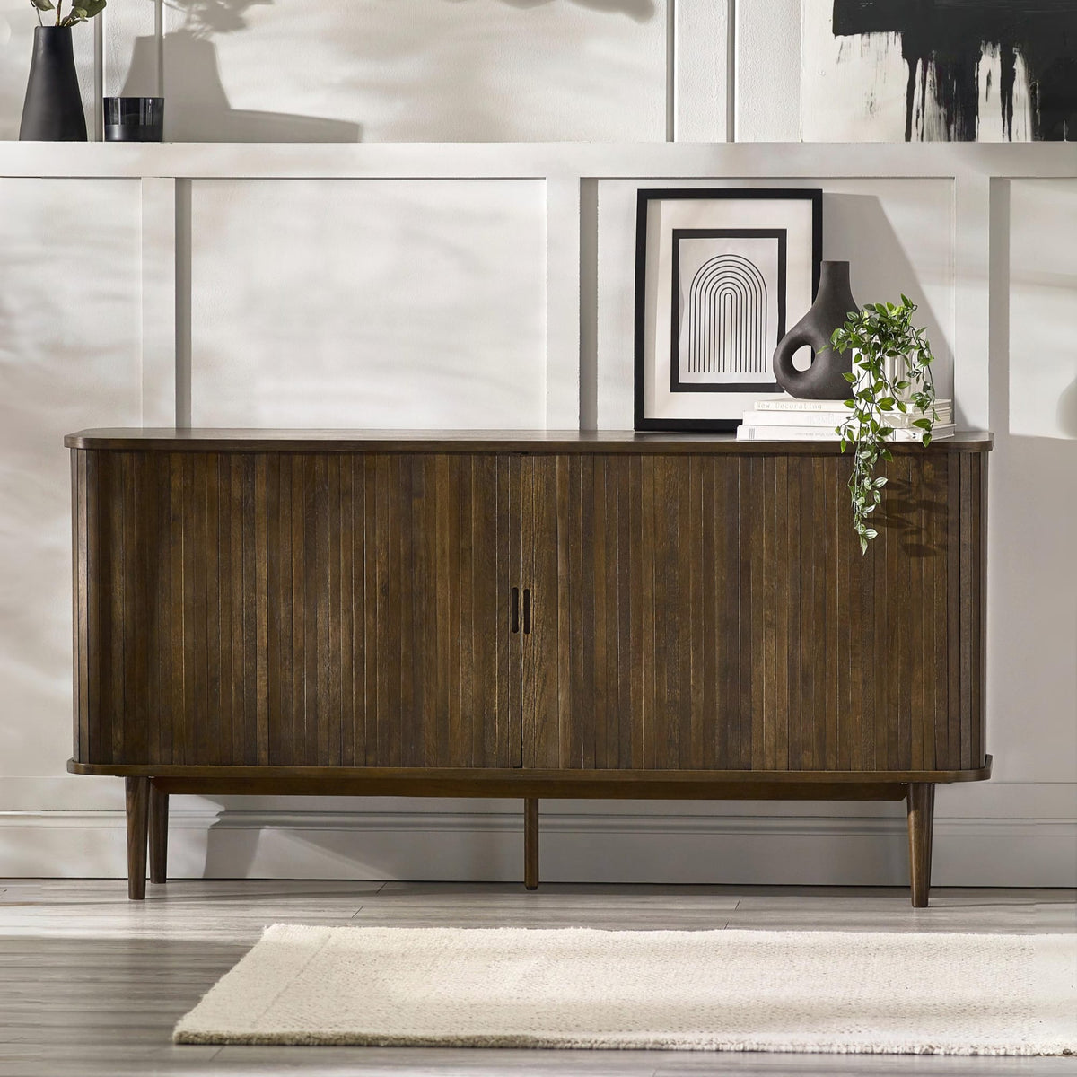 Wooden sideboard in a modern interior setting with decor elements.