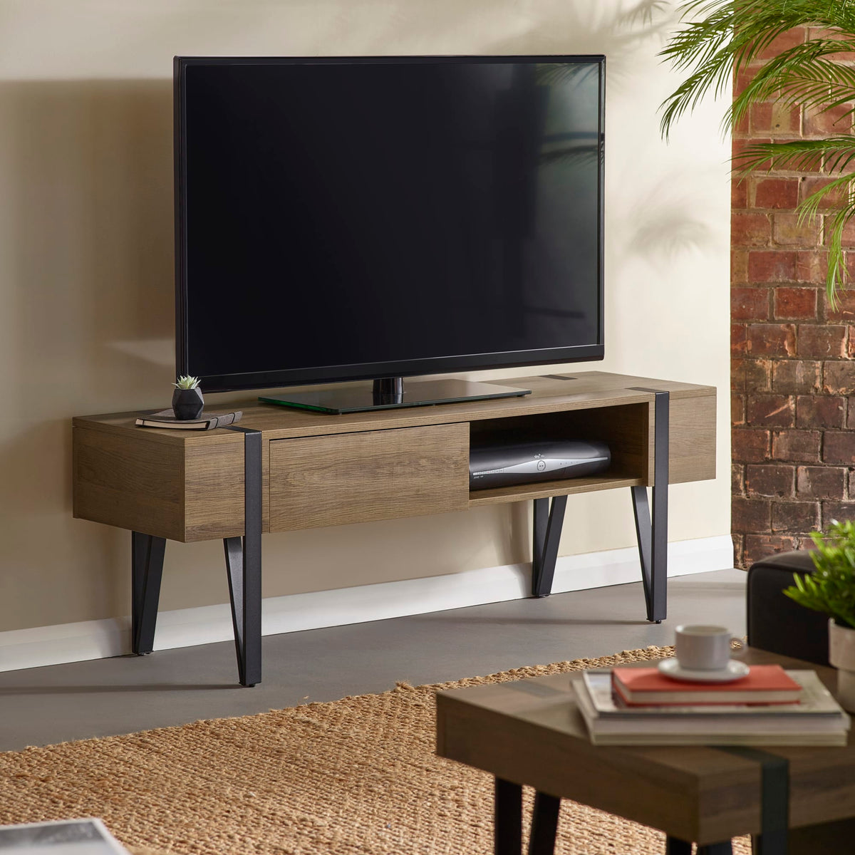 Wooden TV stand with a television in a living room setting.
