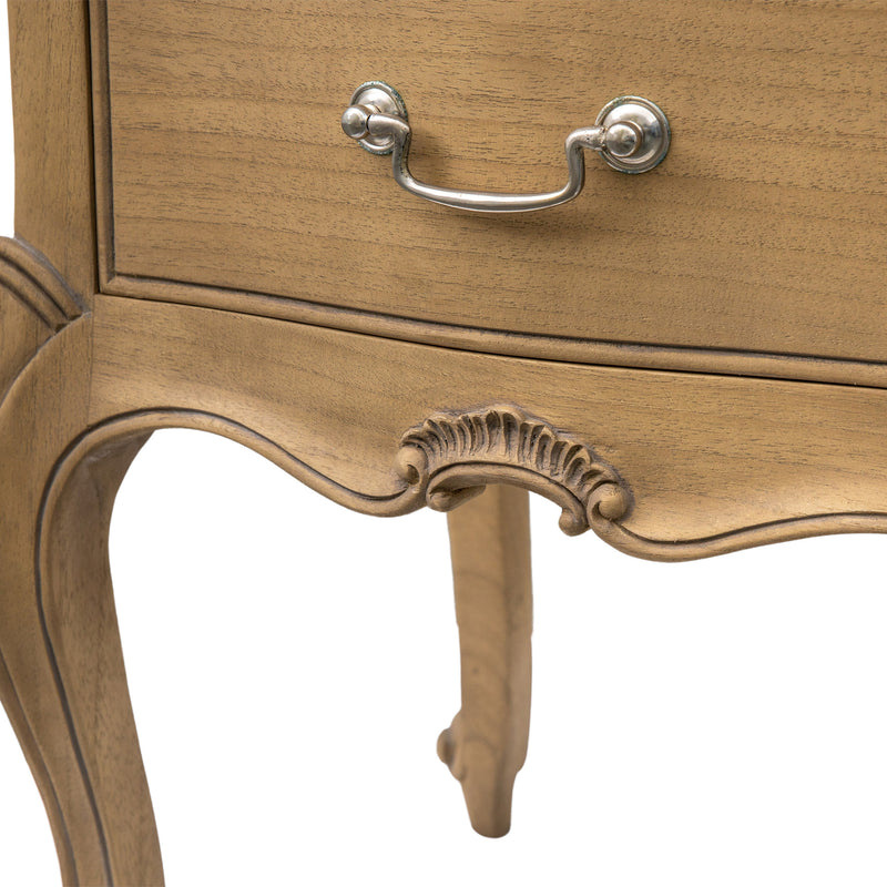 Close-up of a wooden drawer with decorative carvings and a metal handle on a white background.