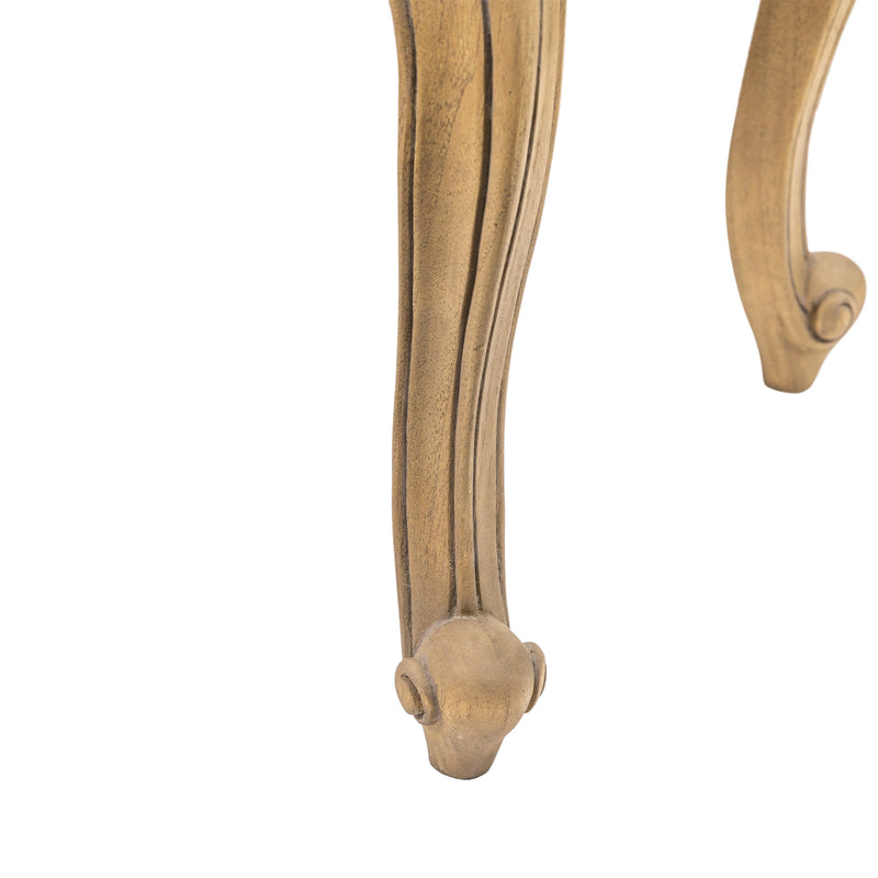 Wooden furniture leg with decorative scrollwork on a white background