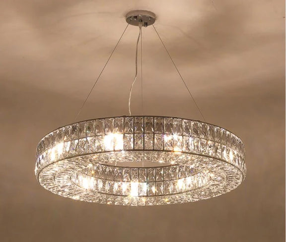 Warm-lit crystal chandelier displaying full illumination.