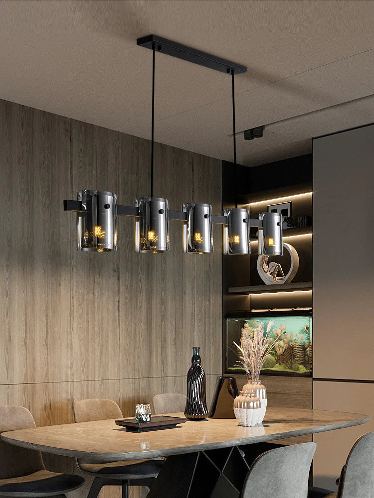 Modern black linear chandelier with six stained-glass cylinder shades.