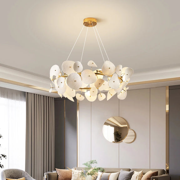 Gold branch chandelier over modern dining table