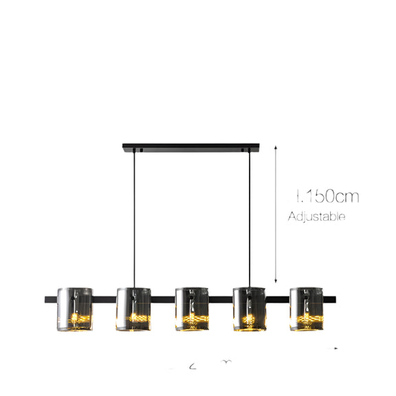 Contemporary glass pendant light fixture suspended over dining table.