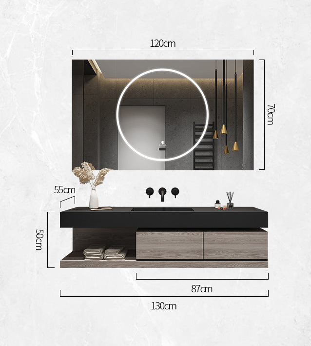 Vanity storage compartment displaying folded towels and accessories.