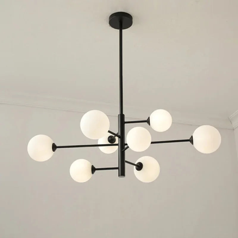 Modern brass globe chandelier with frosted glass shades