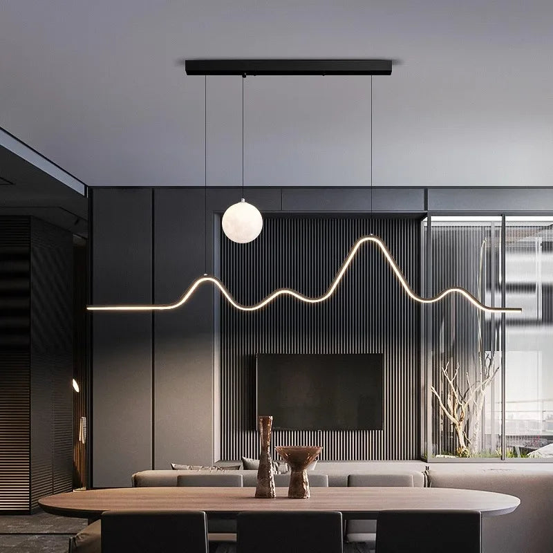 modern wave LED pendant light over dining table