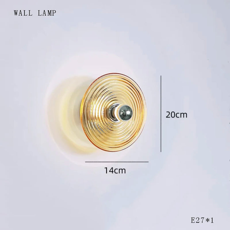 Round glass disc LED pendant light hanging from ceiling