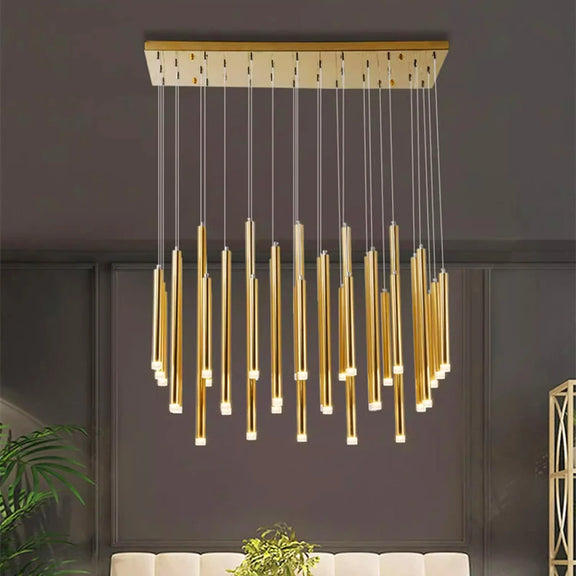 Gold rod cluster LED chandelier hanging from ceiling