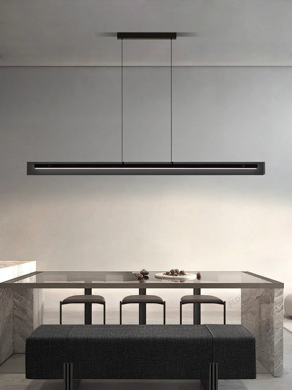 Black linear LED pendant light over dining table