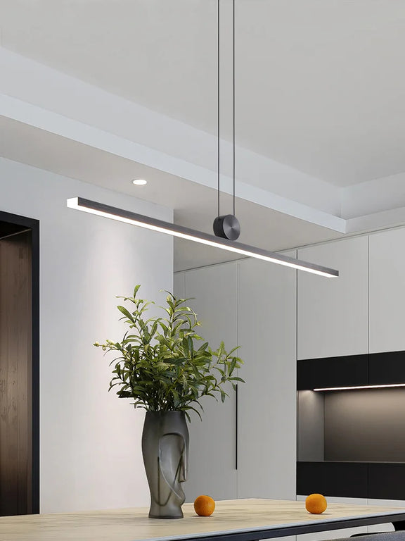 Slim black linear LED pendant light over dining table