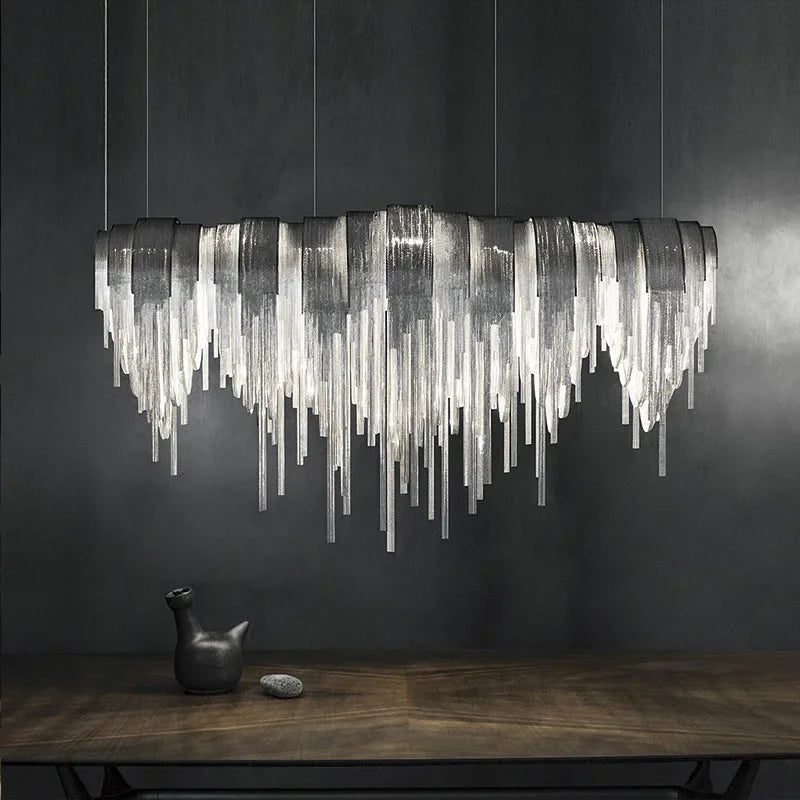Luxury curved chain chandelier silver finish above dining table