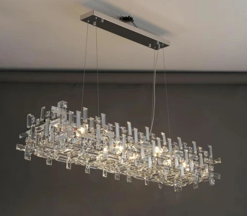 Linear crystal chandelier with chrome frame hanging by cables