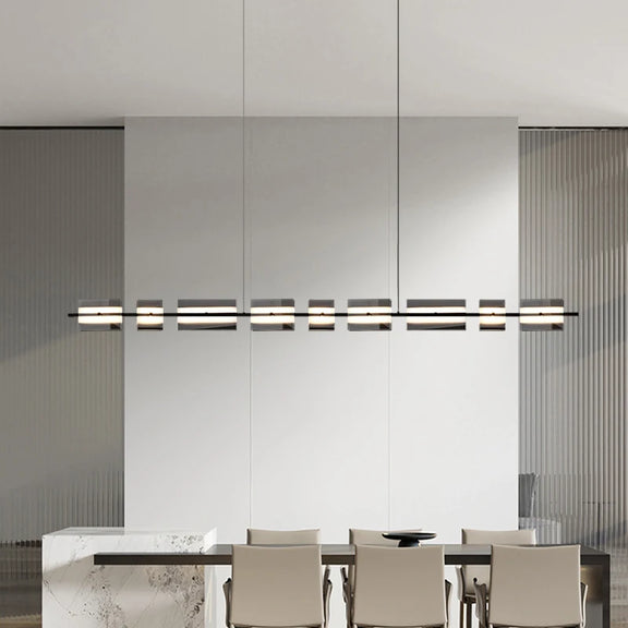 Linear copper LED chandelier suspended from ceiling