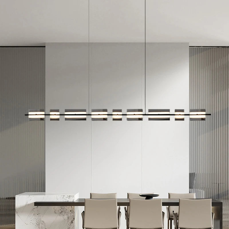 Linear copper LED chandelier suspended from ceiling