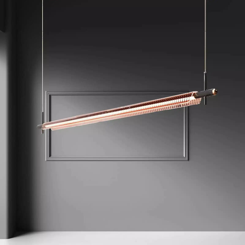 Minimalist gold linear pendant light hanging from ceiling