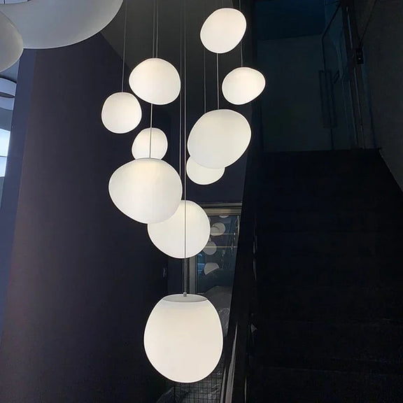 Pebble-shaped staircase chandelier with white glass globes