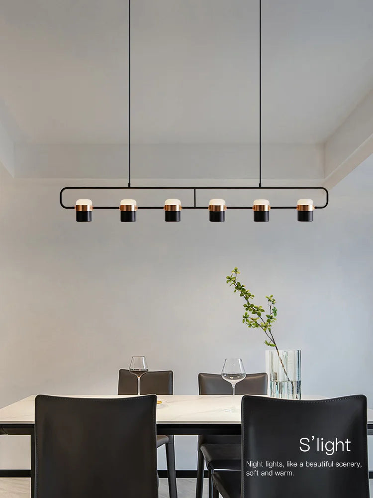 Modern Nordic cylinder pendant light with multiple heads in black finish.