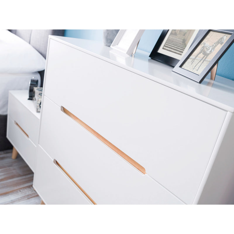 White dresser with gold accents in a bedroom setting