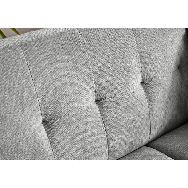 Gray upholstered chair with tufted design on a white background