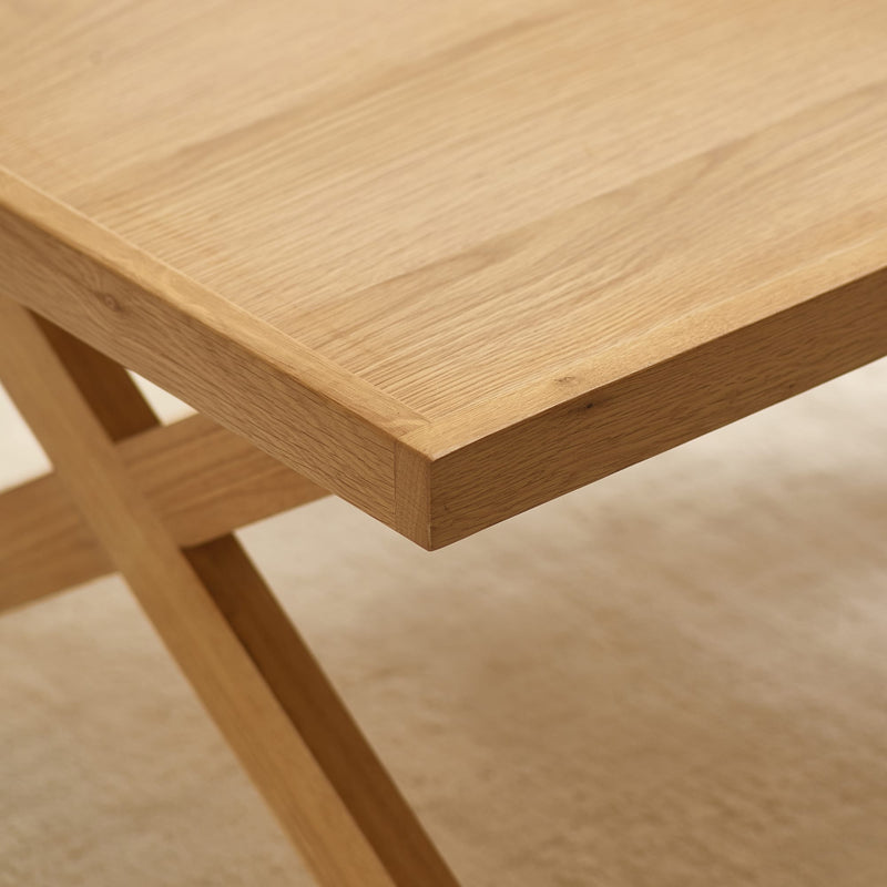 Close-up of a wooden table corner with a blurred background
