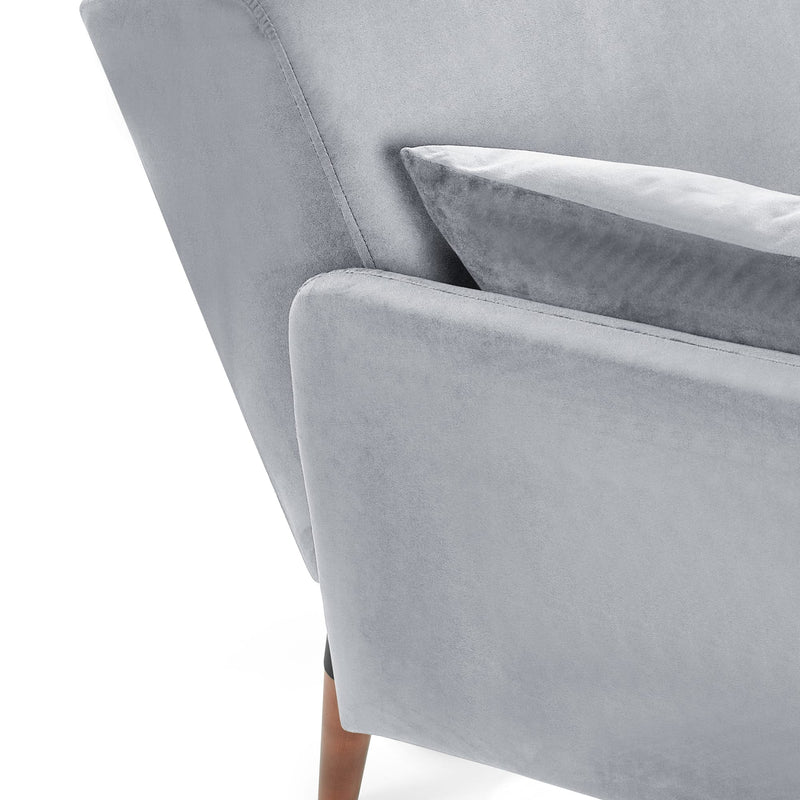 Gray velvet armchair with a cushion on a white background