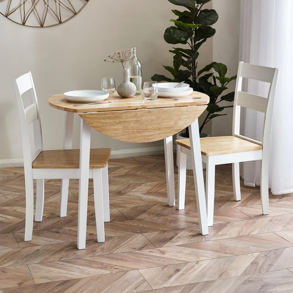 Dining room with wooden table and chairs on a herringbone floor