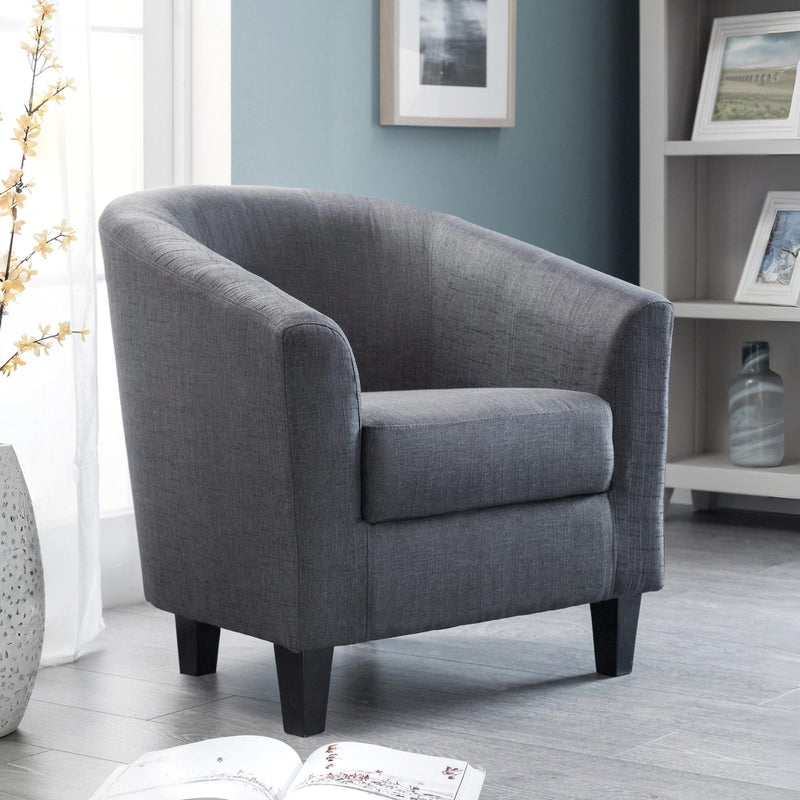 Gray armchair in a room with a book and decorative elements.