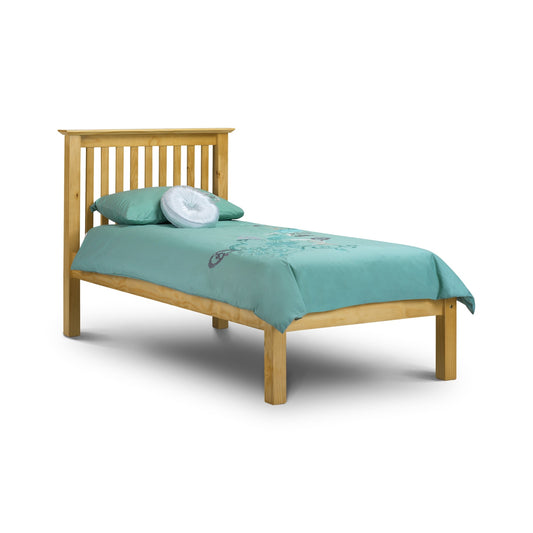 Wooden bed with teal bedding and pillows on a white background