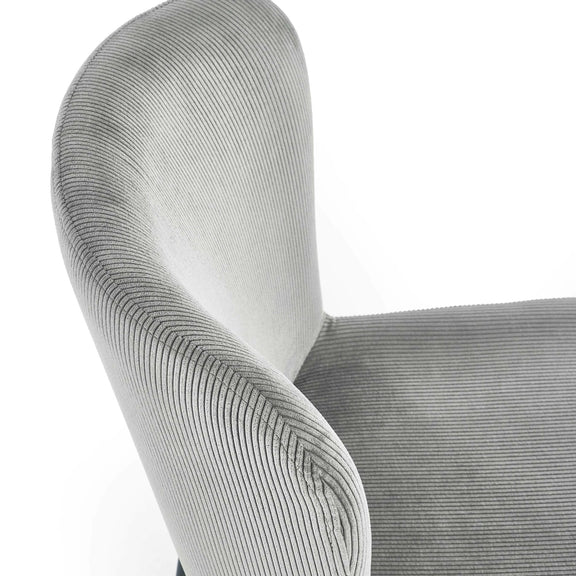 Close-up of a textured gray chair armrest on a white background