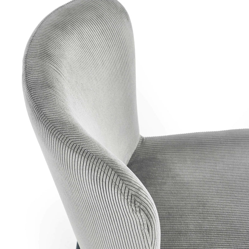 Close-up of a textured gray chair armrest on a white background
