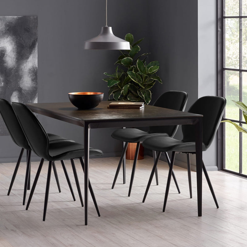 Dining room with a wooden table and black chairs in a modern interior setting.