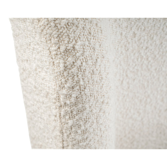 Close-up of a textured white pillow with a subtle pattern.