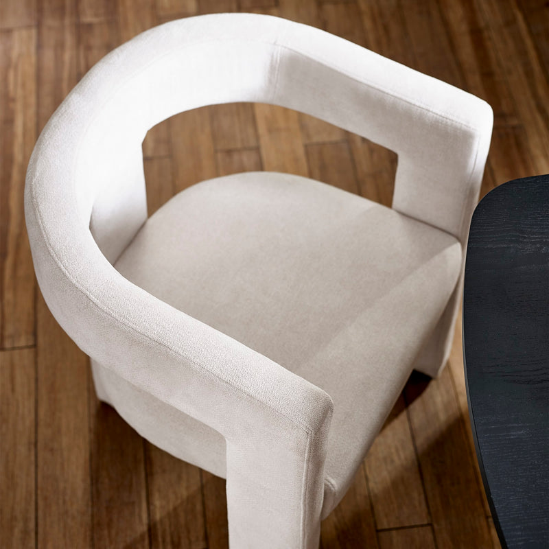 White chair with black footrest on a wooden floor