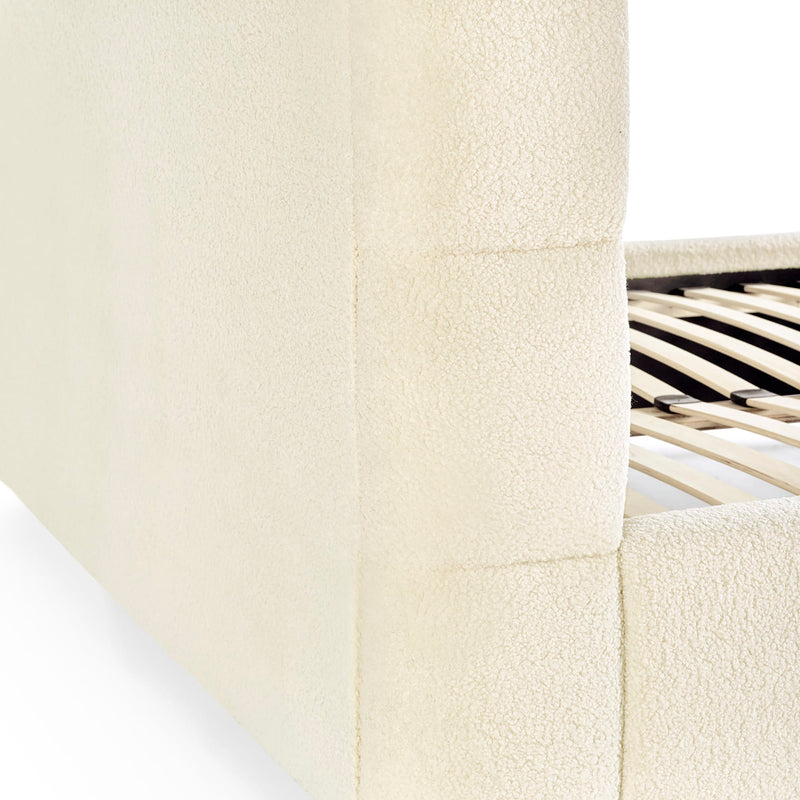 Close-up of a textured white surface with a metallic chair leg in the corner.