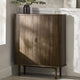 Wooden cabinet with a plant on top in a room with sunlight filtering through.