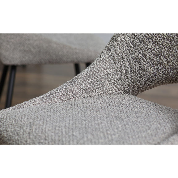 Close-up of a textured gray chair with a blurred background