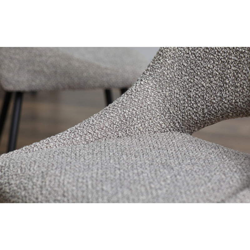 Close-up of a textured gray chair with a blurred background