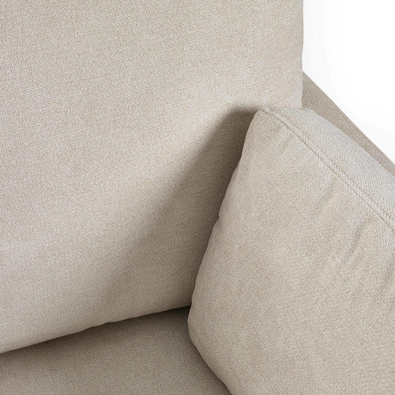 Close-up of a beige upholstered chair corner