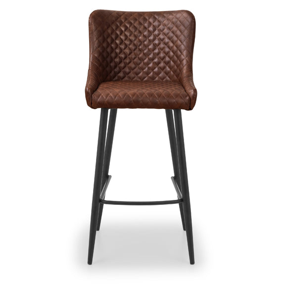 Brown quilted bar stool with black legs on a white background