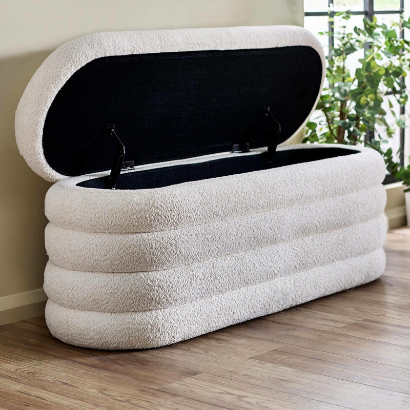 Inflatable storage bench with a textured surface on a wooden floor.