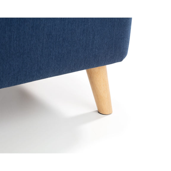 Blue upholstered chair with wooden leg on a white background