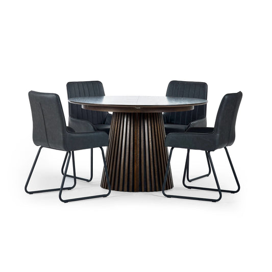 Round dining table with four black chairs on a white background