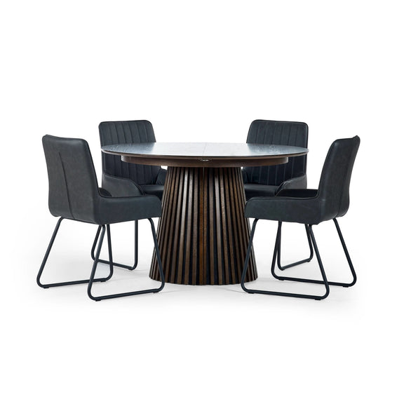 Round dining table with four black chairs on a white background