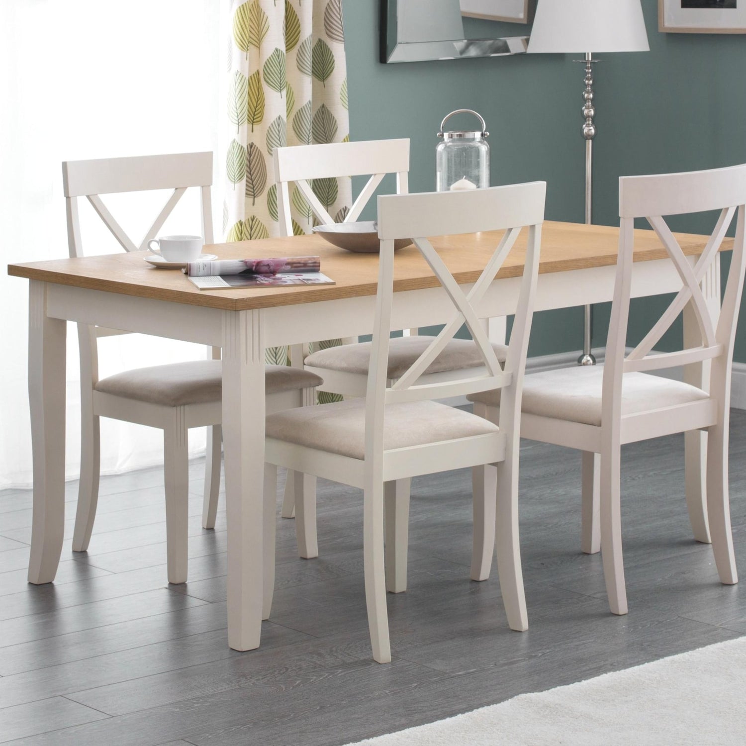 Dining room with a wooden table and white chairs on a gray floor.