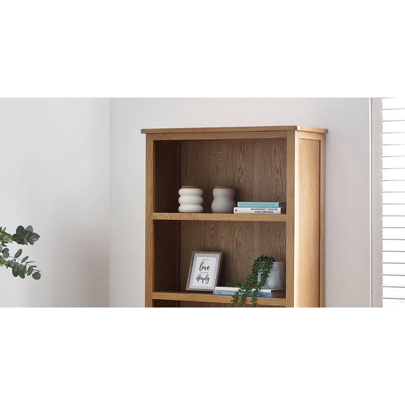 Wooden bookshelf with decorative items against a white wall