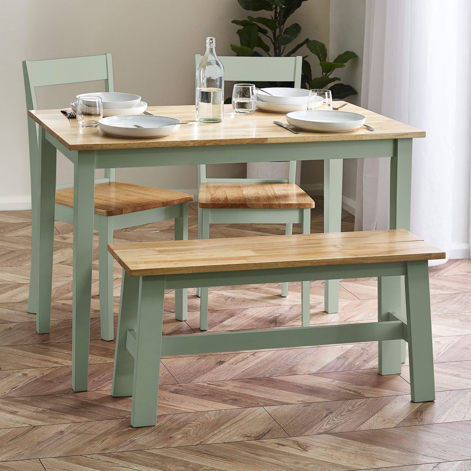 Dining table set with chairs and a bench on a wooden floor