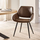 Brown leather chair with black metal legs in a room with a desk and curtains.