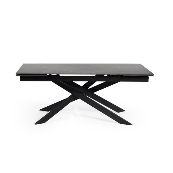 Black dining table with X-shaped legs on a white background